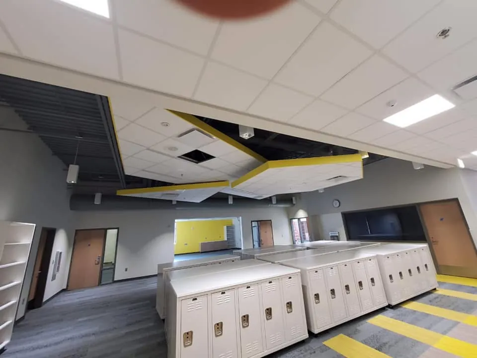 Commercial cafeteria with a yellow accent ceiling and new lockers