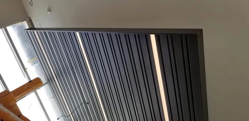 Warm wood slat feature ceiling and wall by Skampy Acoustical, Sioux Falls SD